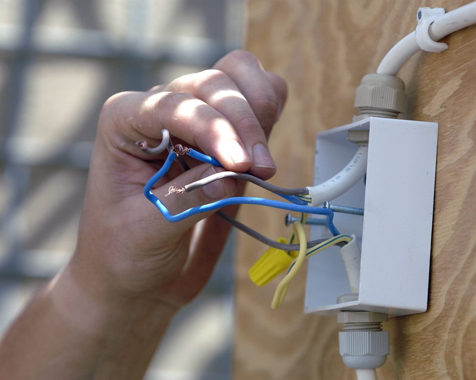 An electrician at a service panel